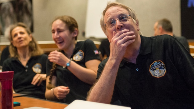 Members of the New Horizons science team react to seeing the spacecraft's last and sharpest image of Pluto. Credit: Bill Ingalls/NASA